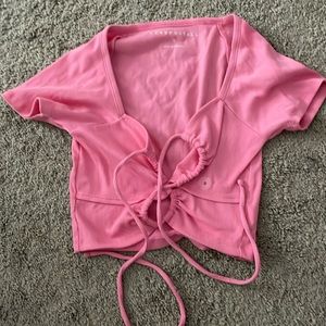 Pink crop top with two holes in the front